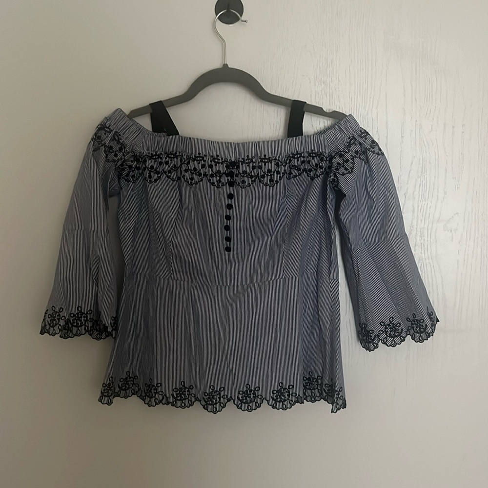 summer striped top with embroidery on end of sleeves, bottom, and neckline.